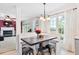 Cozy dining area featuring bench seating, a modern light fixture, and large windows overlooking the backyard at 107 Canyon Run, Cary, NC 27513