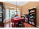Dining room with hardwood floors, large bay windows, and a stylish light fixture creating an inviting atmosphere at 107 Canyon Run, Cary, NC 27513