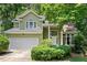 Charming two-story home featuring a two-car garage and a well-maintained front yard with mature landscaping at 107 Canyon Run, Cary, NC 27513