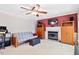 Comfortable living room with a fireplace, ceiling fan, and a flatscreen TV mounted on the wall at 107 Canyon Run, Cary, NC 27513