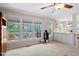Sunlit living room with large windows showcasing the backyard deck, perfect for relaxation and entertaining at 107 Canyon Run, Cary, NC 27513