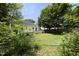 Backyard with lush greenery, home exterior, wooden deck and privacy fence at 109 Perry Farms Dr, Apex, NC 27502