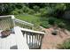 Backyard deck leading to brick patio with bird bath, surrounded by lush greenery at 109 Perry Farms Dr, Apex, NC 27502