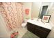 Traditional bathroom with patterned shower curtain, and single vanity with dark wood cabinets at 109 Perry Farms Dr, Apex, NC 27502