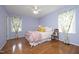 Bedroom features hardwood floors, ceiling fan, and floral curtains at 109 Perry Farms Dr, Apex, NC 27502