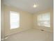 This bedroom has neutral walls, two windows, and neutral carpet at 109 Perry Farms Dr, Apex, NC 27502