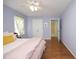 Spacious bedroom with hardwood floors, ceiling fan, and light walls at 109 Perry Farms Dr, Apex, NC 27502
