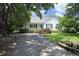 Inviting home featuring a front porch, charming shutters, and mature landscaping at 109 Perry Farms Dr, Apex, NC 27502