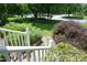 Beautifully landscaped front yard with mature trees and a well-manicured lawn at 109 Perry Farms Dr, Apex, NC 27502