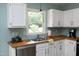 Bright kitchen showcasing butcher block countertops and stainless-steel appliances at 109 Perry Farms Dr, Apex, NC 27502