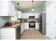 A modern kitchen with stainless steel appliances, light cabinetry, and butcher block countertops at 109 Perry Farms Dr, Apex, NC 27502