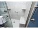 Modern shower with white tile, glass door, built-in shelves and shower seat at 109 Perry Farms Dr, Apex, NC 27502