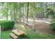 Backyard featuring mature trees, a hammock, and a picnic table perfect for peaceful outdoor enjoyment at 11217 Maplecroft Ct, Raleigh, NC 27617