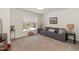 Cozy bonus bedroom with a comfortable couch and natural light from the window at 11217 Maplecroft Ct, Raleigh, NC 27617