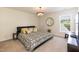 Bedroom featuring a black bed frame, neutral color palette, and large window at 11217 Maplecroft Ct, Raleigh, NC 27617