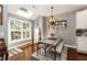 Bright dining room featuring a skylight, table with bench seating and a rustic light fixture at 11217 Maplecroft Ct, Raleigh, NC 27617