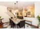 Open-concept dining area with stylish lighting, hardwood floors and staircase at 11217 Maplecroft Ct, Raleigh, NC 27617