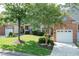 Charming brick townhome with well-manicured lawn and mature trees providing shade and curb appeal at 11217 Maplecroft Ct, Raleigh, NC 27617