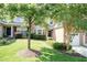 Attractive townhome featuring a well-maintained lawn, mature tree, and inviting entrance at 11217 Maplecroft Ct, Raleigh, NC 27617