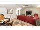 Cozy living room with a plush red sectional, rug, and comfortable seating at 11217 Maplecroft Ct, Raleigh, NC 27617
