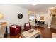 Elegant living room with hardwood floors, cozy seating, and a view of the dining area at 11217 Maplecroft Ct, Raleigh, NC 27617