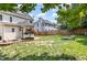 Backyard featuring a lounge chair, a lush lawn, a fire pit, and a small Japanese maple tree at 113 Sycamore Ridge Ln, Holly Springs, NC 27540