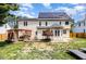 Spacious backyard featuring a fireplace, a gazebo, solar panels, and a fenced perimeter at 113 Sycamore Ridge Ln, Holly Springs, NC 27540