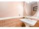Charming powder room with pedestal sink, decorative wallpaper, and classic fixtures at 113 Sycamore Ridge Ln, Holly Springs, NC 27540