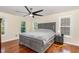 Comfortable bedroom with a large bed, hardwood floors, and lots of natural light at 113 Sycamore Ridge Ln, Holly Springs, NC 27540