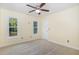 Bright bedroom with carpeted floors and two large windows, offering plenty of natural light at 113 Sycamore Ridge Ln, Holly Springs, NC 27540