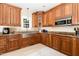 Stylish kitchen with stainless steel sink, granite countertops, and custom wood cabinetry at 113 Sycamore Ridge Ln, Holly Springs, NC 27540