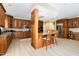 Well-equipped kitchen includes a breakfast bar, custom cabinets, and stainless steel appliances at 113 Sycamore Ridge Ln, Holly Springs, NC 27540