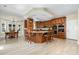 Spacious kitchen boasts an island with seating, granite countertops, and modern appliances at 113 Sycamore Ridge Ln, Holly Springs, NC 27540