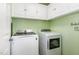 Functional laundry room includes a washer, dryer, and ample storage space at 113 Sycamore Ridge Ln, Holly Springs, NC 27540