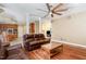 Open room with hardwood floors, neutral walls, ceiling fan, and comfortable seating at 113 Sycamore Ridge Ln, Holly Springs, NC 27540