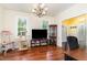 Bright room with wood floors, neutral walls, a display case, and natural light from the windows at 113 Sycamore Ridge Ln, Holly Springs, NC 27540