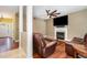 Cozy room features a fireplace, ceiling fan, hardwood flooring, and comfortable seating at 113 Sycamore Ridge Ln, Holly Springs, NC 27540