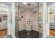Modern shower with dual showerheads, a built-in bench, and stylish black-tiled flooring at 113 Sycamore Ridge Ln, Holly Springs, NC 27540