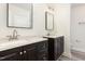 Bathroom featuring dual sinks, updated mirrors and lighting, and modern fixtures at 1209 Waterford Green Dr, Apex, NC 27502