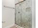 New bathroom shower featuring decorative tile work, glass door, and sleek fixtures at 1209 Waterford Green Dr, Apex, NC 27502