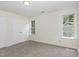 Neutral bedroom with carpeted floors and natural light from two windows at 1209 Waterford Green Dr, Apex, NC 27502