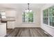 Dining area with natural light from the windows, and laminate flooring at 1209 Waterford Green Dr, Apex, NC 27502