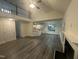 Open-concept living room featuring tall ceilings, a fireplace, and a view into the kitchen at 1209 Waterford Green Dr, Apex, NC 27502