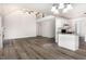 Open-concept living room featuring high ceilings and an adjacent kitchen with granite countertops at 1209 Waterford Green Dr, Apex, NC 27502