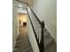 Bright foyer featuring a carpeted staircase with white railing and access to the living room at 1209 Waterford Green Dr, Apex, NC 27502