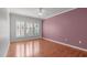 Spacious bedroom with hardwood floors, neutral paint, and plantation shutters offering lots of natural light at 128 Arvind Oaks Cir, Cary, NC 27519