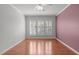 Bedroom featuring hardwood floors and a large window for natural light and a closet at 128 Arvind Oaks Cir, Cary, NC 27519