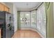 Cozy breakfast nook featuring large windows with shutters, hardwood flooring, and plenty of natural light in kitchen at 128 Arvind Oaks Cir, Cary, NC 27519