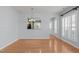 Bright dining area with hardwood floors, a view into the kitchen, and access to the front entry at 128 Arvind Oaks Cir, Cary, NC 27519