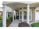 Inviting front entrance with well-kept landscaping, white columns, bay windows, and a covered porch for guests at 128 Arvind Oaks Cir, Cary, NC 27519